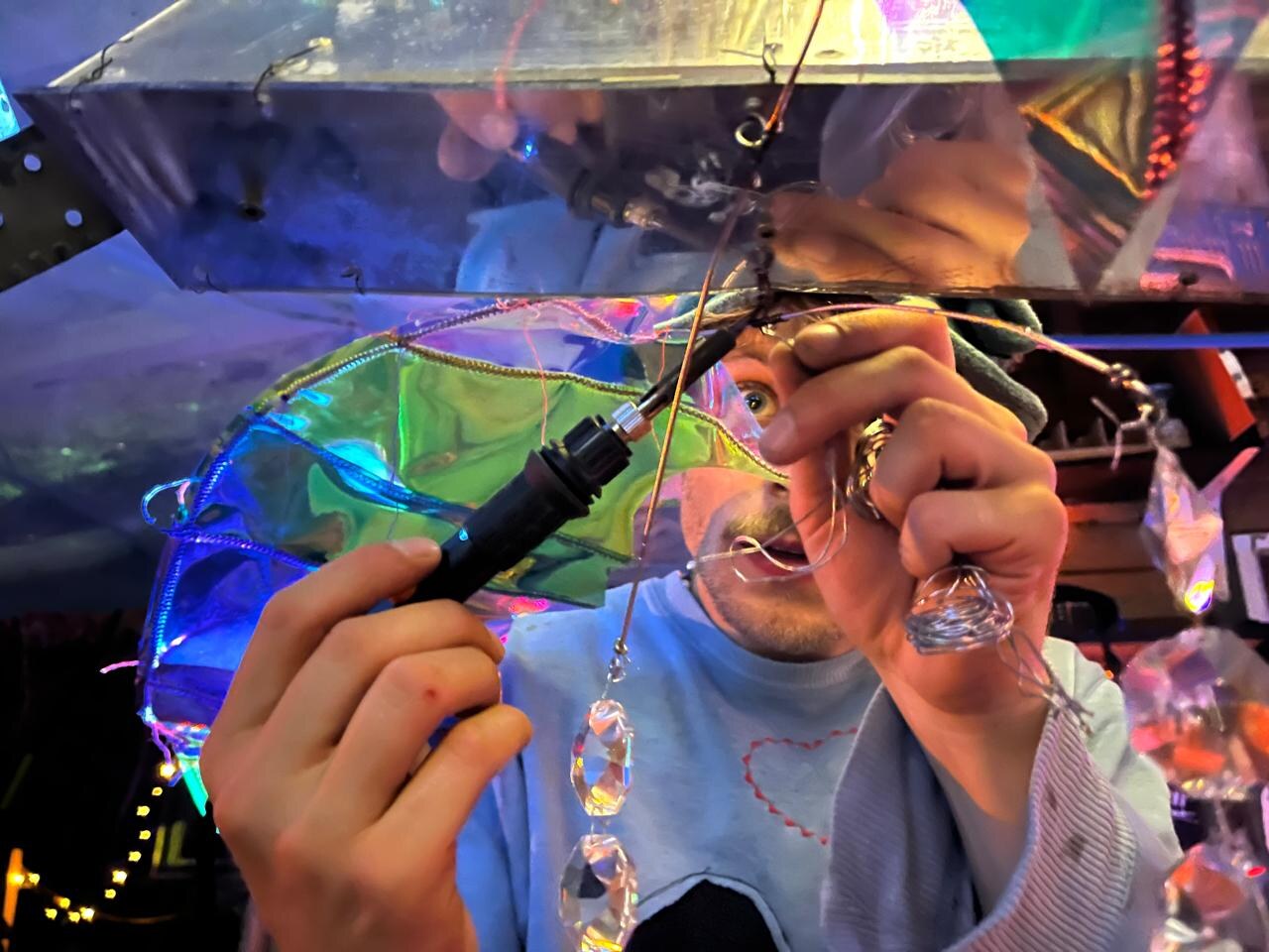 Tobias Eder building an artwork with found materials